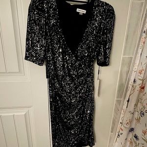 Black and silver sequin mid long sleeved Calvin Klein dress. Never worn!